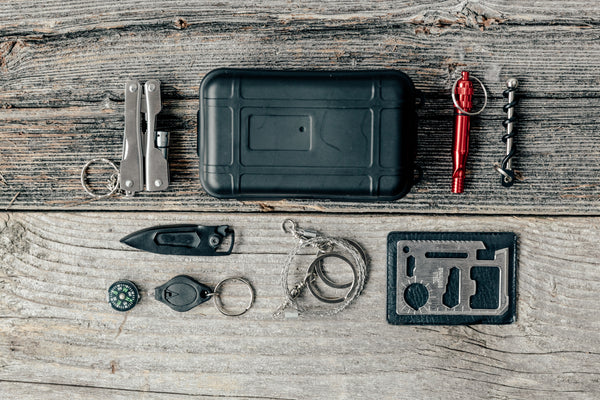 camping pocket survival kit flatlay and knife